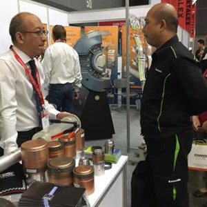 A man is showing products to another man at a trade show.