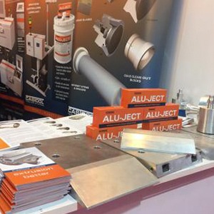ALU-JECT products, with shearing blades and pamphlets on a table.